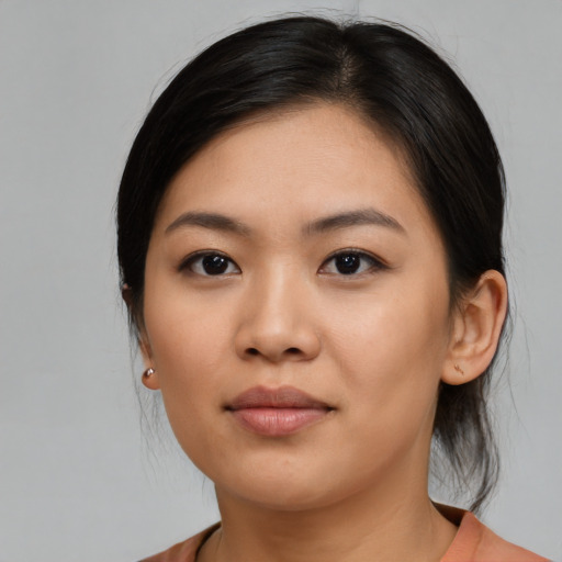Joyful asian young-adult female with medium  black hair and brown eyes