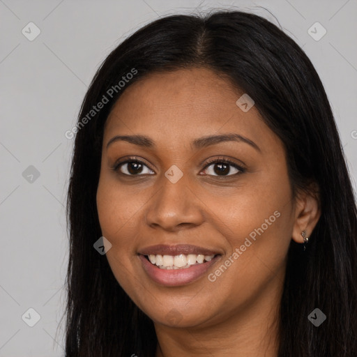 Joyful black young-adult female with long  brown hair and brown eyes