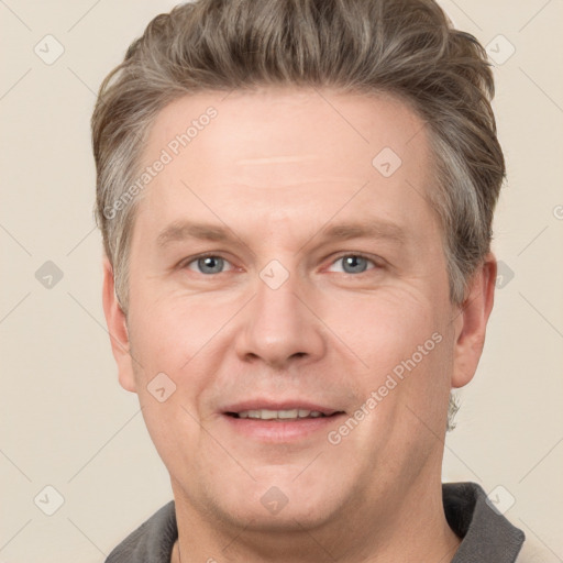 Joyful white adult male with short  brown hair and grey eyes