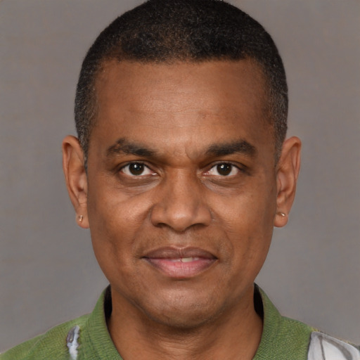 Joyful latino adult male with short  brown hair and brown eyes