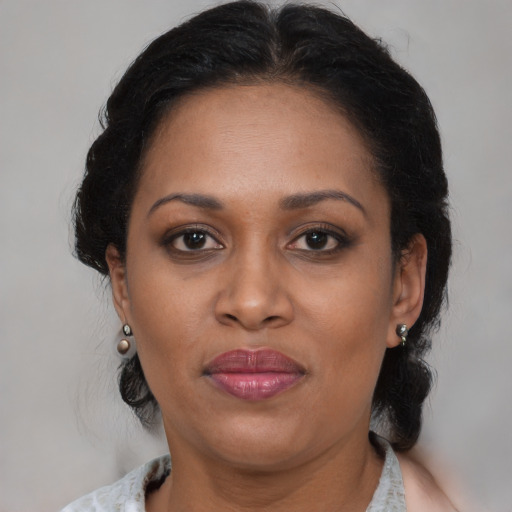 Joyful black adult female with medium  brown hair and brown eyes