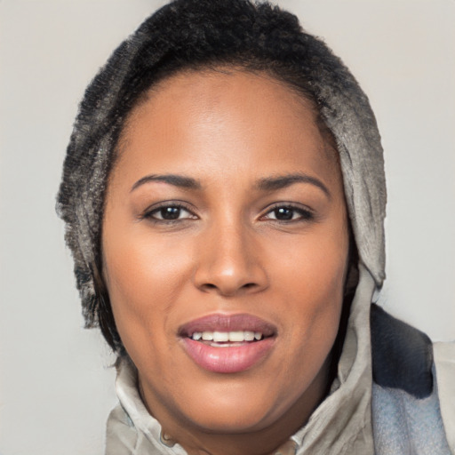 Joyful black young-adult female with long  brown hair and brown eyes