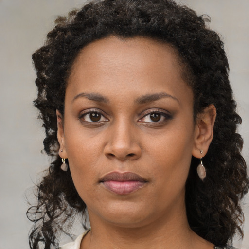 Neutral black young-adult female with medium  brown hair and brown eyes