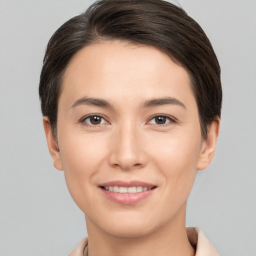 Joyful white young-adult female with short  brown hair and brown eyes