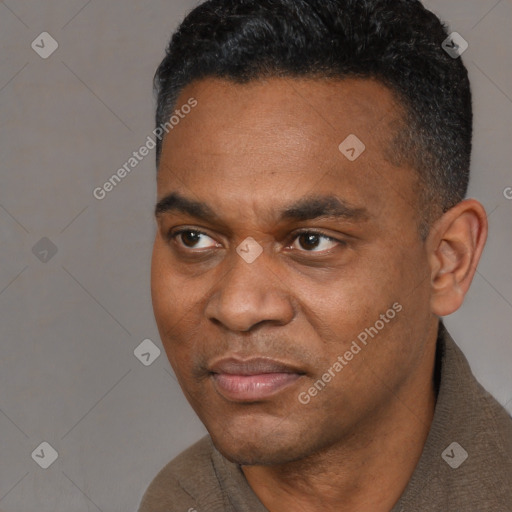 Joyful black young-adult male with short  black hair and brown eyes