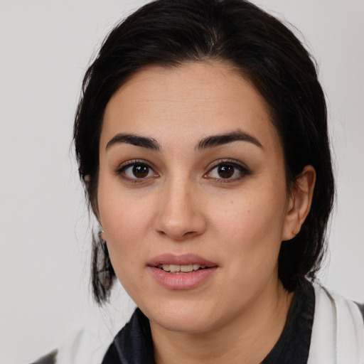 Joyful white young-adult female with medium  black hair and brown eyes