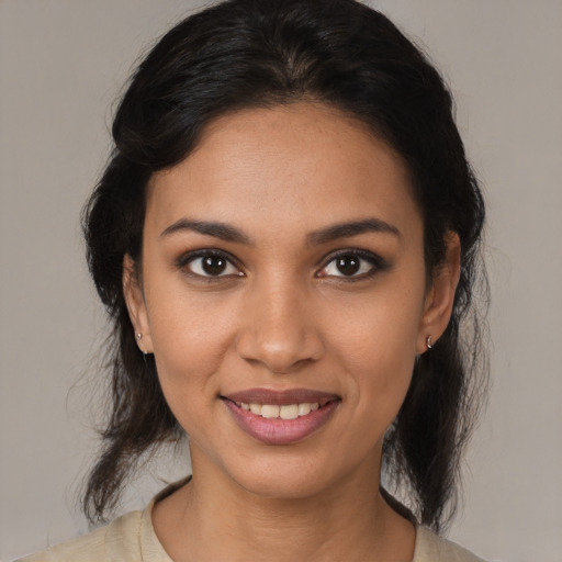 Joyful latino young-adult female with medium  brown hair and brown eyes
