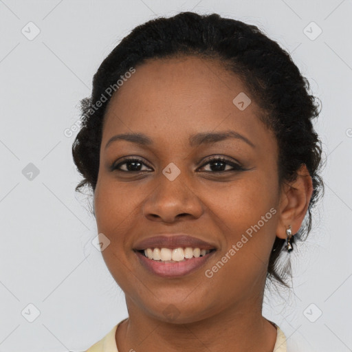 Joyful black young-adult female with short  black hair and brown eyes