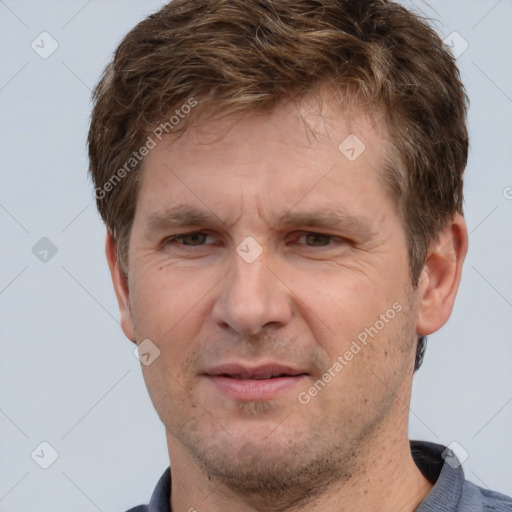 Joyful white adult male with short  brown hair and grey eyes