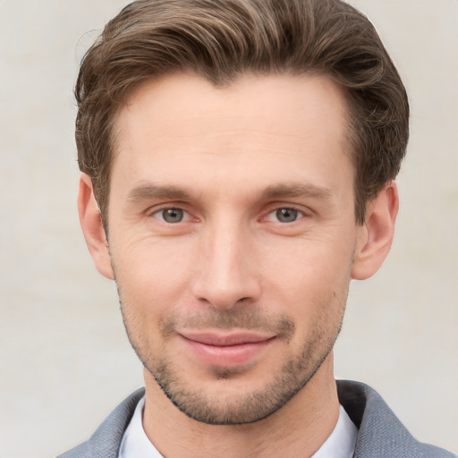 Joyful white young-adult male with short  brown hair and grey eyes