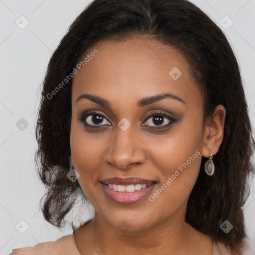 Joyful black young-adult female with long  brown hair and brown eyes