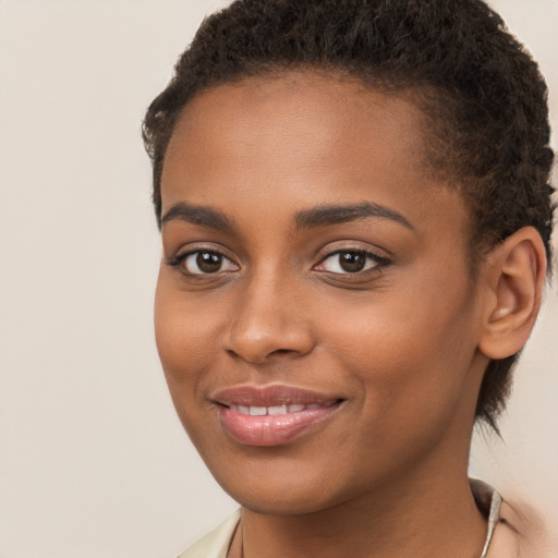 Joyful black young-adult female with short  brown hair and brown eyes