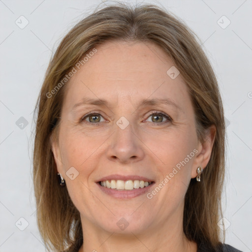 Joyful white adult female with medium  brown hair and grey eyes