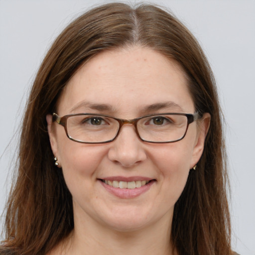 Joyful white young-adult female with long  brown hair and blue eyes