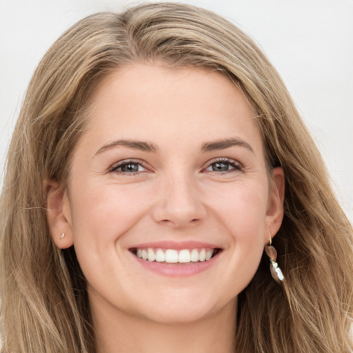 Joyful white young-adult female with long  brown hair and green eyes