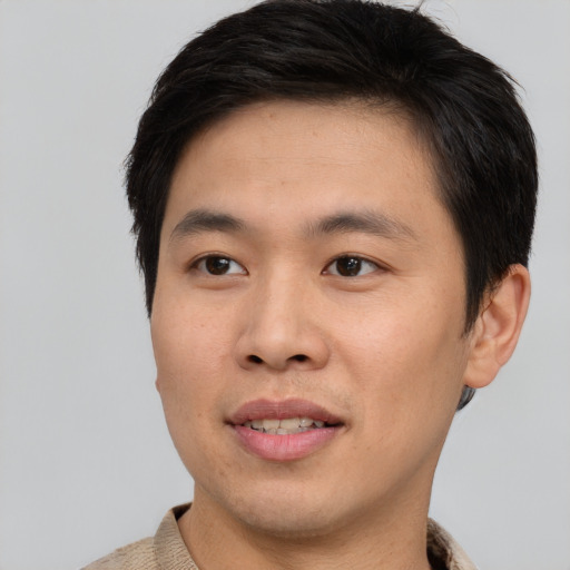 Joyful asian young-adult male with short  brown hair and brown eyes