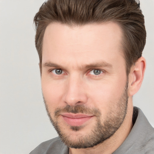 Joyful white adult male with short  brown hair and brown eyes