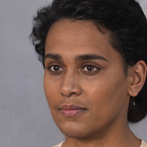 Neutral black young-adult female with short  black hair and brown eyes