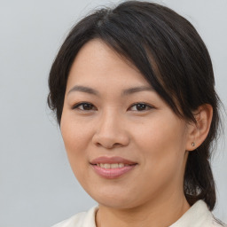 Joyful asian young-adult female with medium  brown hair and brown eyes