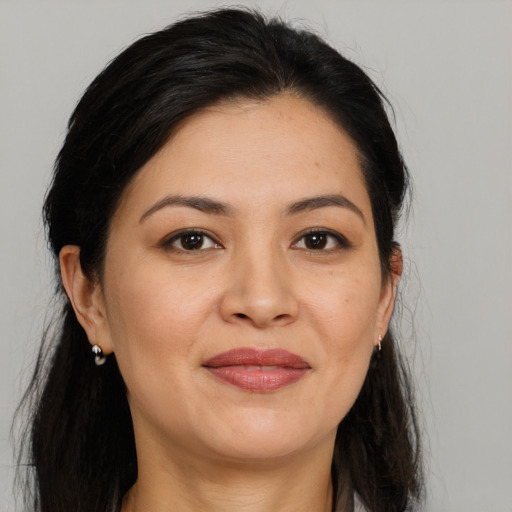 Joyful asian young-adult female with long  brown hair and brown eyes