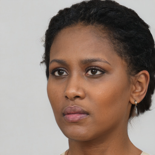 Neutral black young-adult female with short  brown hair and brown eyes