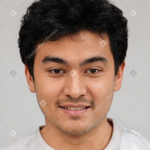 Joyful white young-adult male with short  black hair and brown eyes