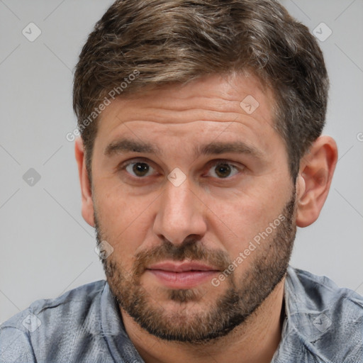 Joyful white adult male with short  brown hair and brown eyes