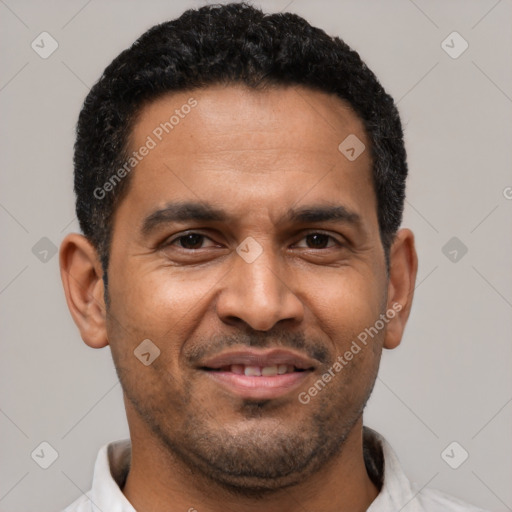 Joyful latino adult male with short  brown hair and brown eyes