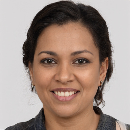 Joyful latino young-adult female with medium  brown hair and brown eyes