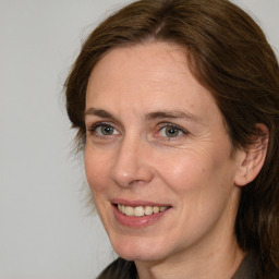 Joyful white adult female with long  brown hair and brown eyes