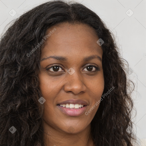 Joyful black young-adult female with long  brown hair and brown eyes