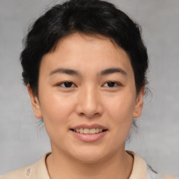 Joyful asian young-adult female with short  brown hair and brown eyes