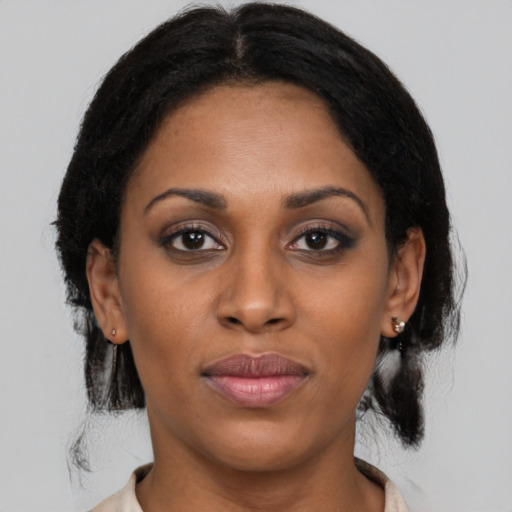 Joyful latino young-adult female with medium  brown hair and brown eyes