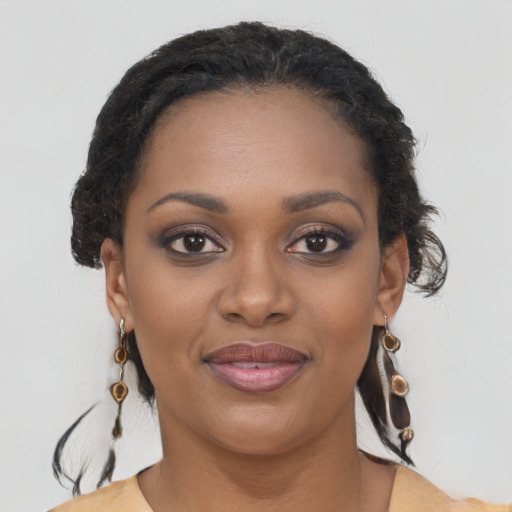 Joyful black young-adult female with long  brown hair and brown eyes