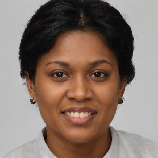 Joyful black young-adult female with short  brown hair and brown eyes
