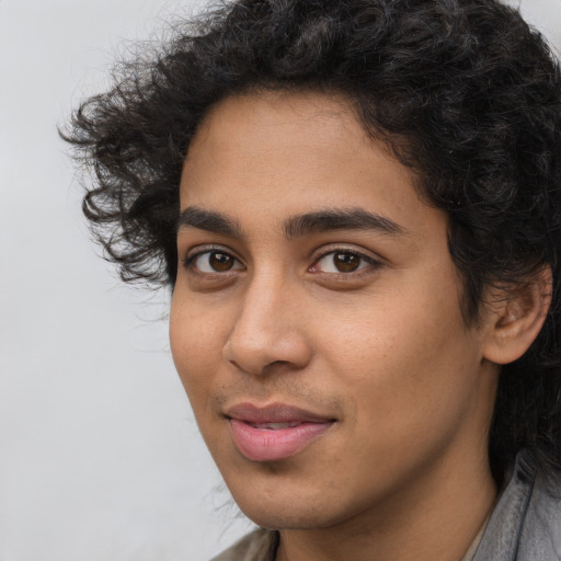 Joyful latino young-adult male with long  black hair and brown eyes