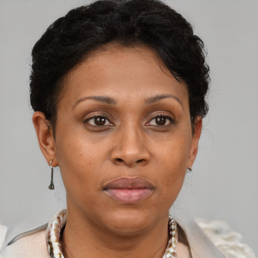 Joyful latino adult female with short  brown hair and brown eyes