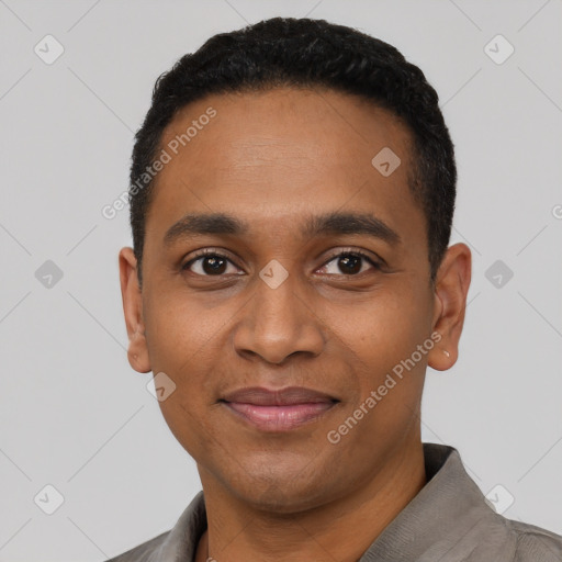 Joyful black young-adult male with short  black hair and brown eyes