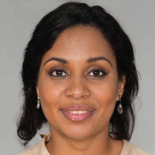Joyful black young-adult female with medium  brown hair and brown eyes