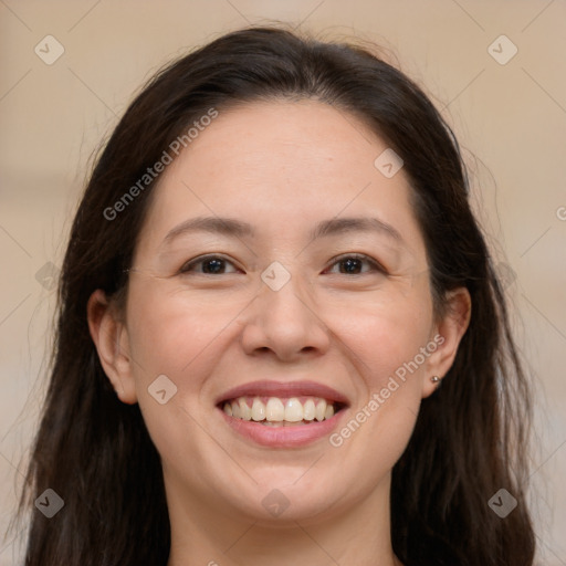 Joyful white adult female with long  brown hair and brown eyes