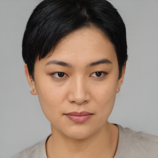 Joyful asian young-adult female with short  black hair and brown eyes