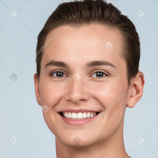 Joyful white young-adult female with short  brown hair and brown eyes