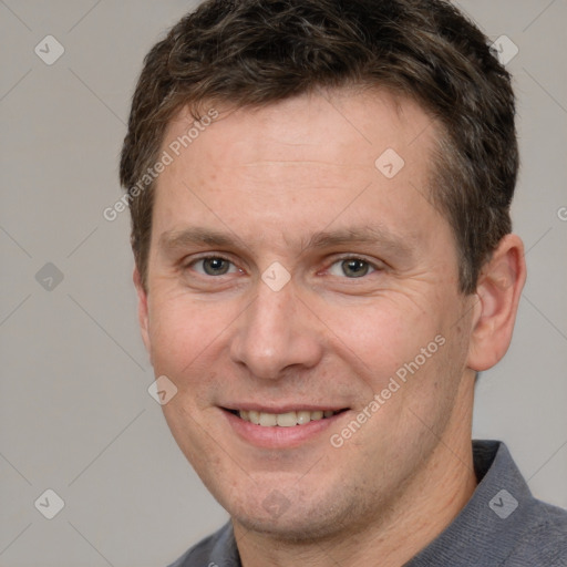 Joyful white adult male with short  brown hair and brown eyes