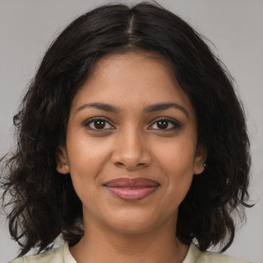 Joyful black young-adult female with medium  brown hair and brown eyes