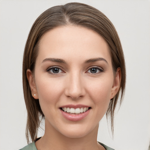 Joyful white young-adult female with medium  brown hair and grey eyes