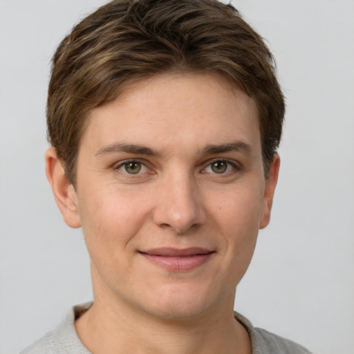 Joyful white young-adult female with short  brown hair and grey eyes