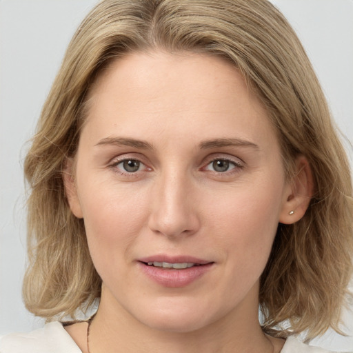 Joyful white young-adult female with medium  brown hair and blue eyes