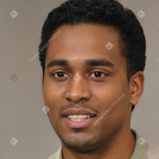 Joyful black young-adult male with short  black hair and brown eyes