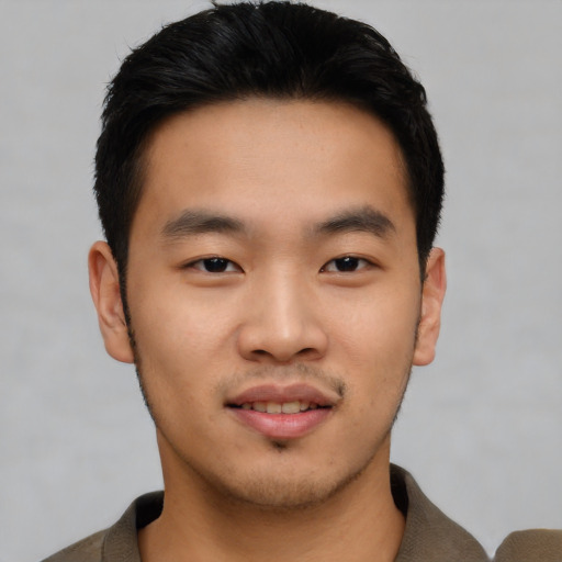 Joyful asian young-adult male with short  black hair and brown eyes