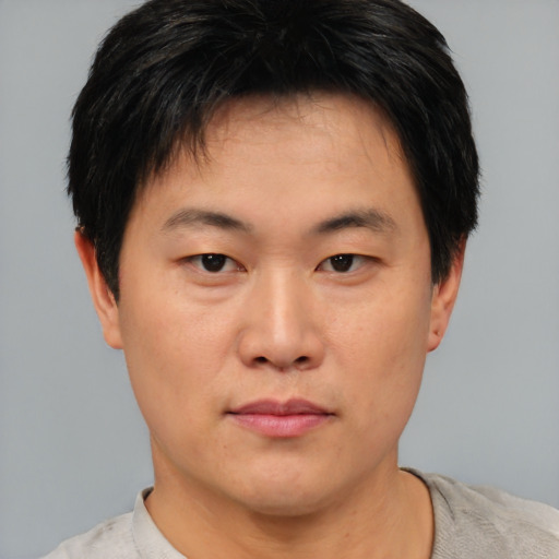 Neutral asian young-adult male with short  brown hair and brown eyes